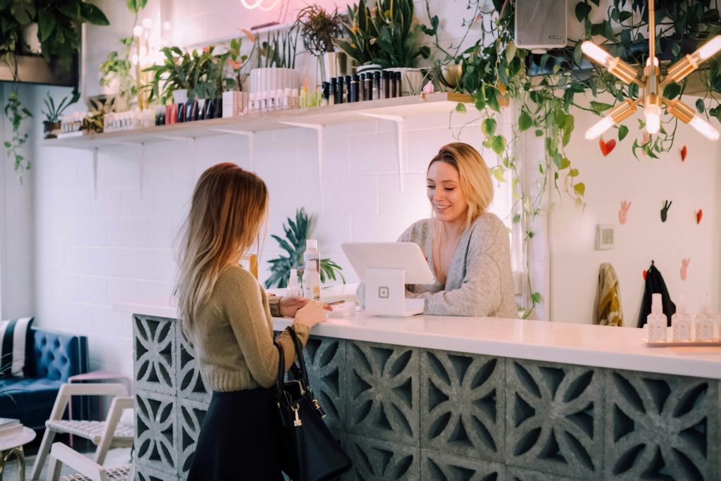 Small business owner serving a customer at the counter