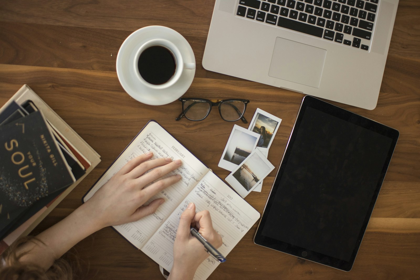 Person writing with a pen in a notebook